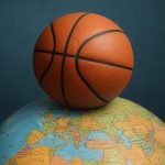 Basketball court with international flags highlighting global career opportunities in the sport