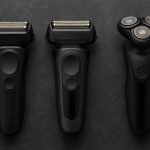Electric shavers for coarse facial hair displayed on a bathroom counter with grooming accessories