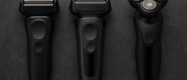 Electric shavers for coarse facial hair displayed on a bathroom counter with grooming accessories