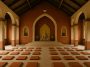 Multi-faith community gathering in a shared spiritual space with teacher and diverse architecture