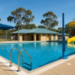 Commercial swimming pool with safety signage and equipment meeting Western Australia compliance standards