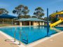 Commercial swimming pool with safety signage and equipment meeting Western Australia compliance standards